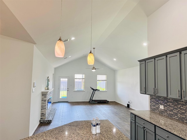 20367 Tembec Dr, New Caney, TX 77357 - kitchen with gray cabinetry, light stone counters, ceiling fan, decorative light fixtures, and dark wood-style flooring