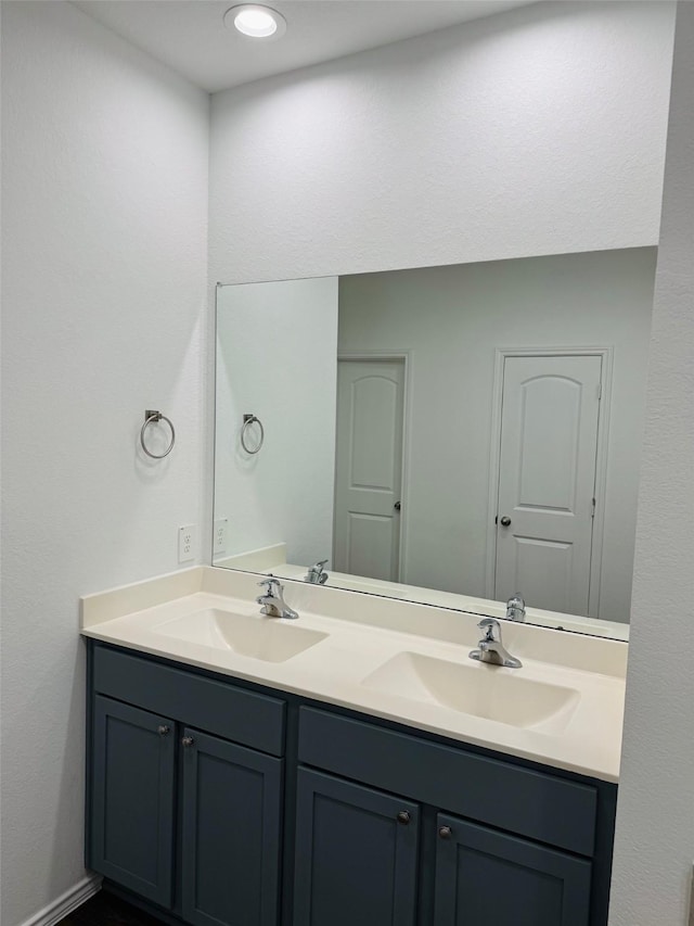 20367 Tembec Dr, New Caney, TX 77357 - bathroom featuring double vanity and baseboards