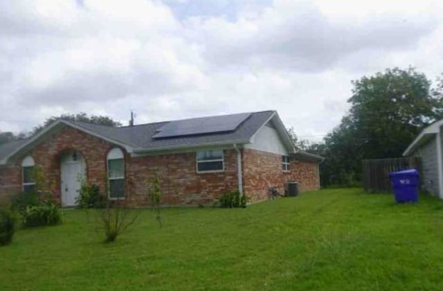 301 S Patricia St, Lacy-Lakeview, TX 76705 - view of home's exterior with solar panels, a yard, and brick siding