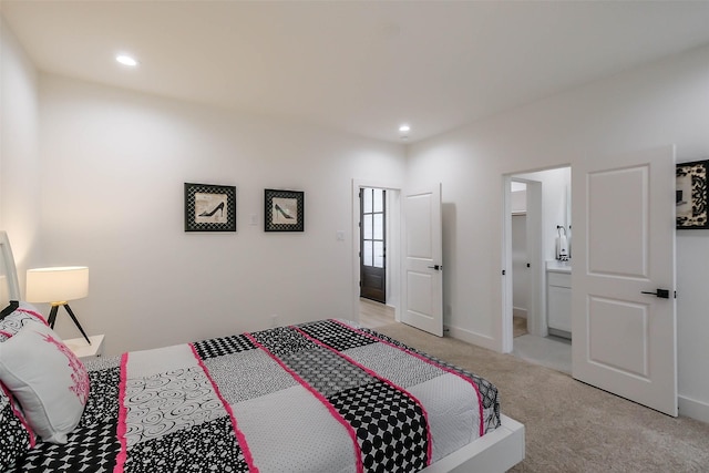 5703E Balbo St, Houston, TX 77091 - bedroom with light colored carpet, recessed lighting, and connected bathroom