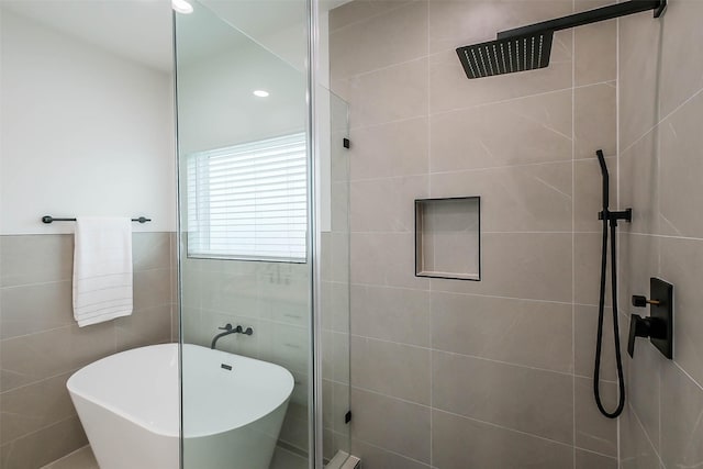 5703E Balbo St, Houston, TX 77091 - bathroom featuring tiled shower, a freestanding bath, tile walls, and recessed lighting