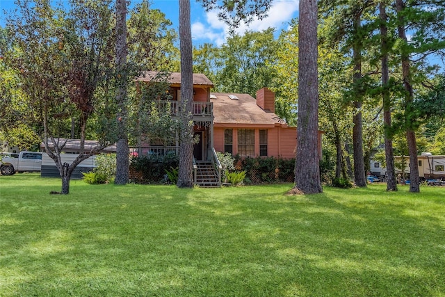 11505 US Highway 190 W, Livingston, TX 77351 - view of front facade featuring a front yard, stairs, and a chimney