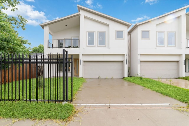 6715 England St, Houston, TX 77021 - contemporary house with stucco siding, a balcony, an attached garage, and driveway