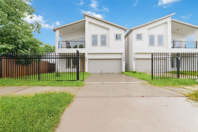 6715 England St, Houston, TX 77021 - view of front facade featuring a balcony, stucco siding, a garage, and concrete driveway