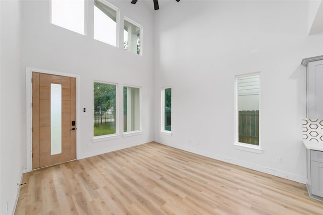 6715 England St, Houston, TX 77021 - foyer with a high ceiling, ceiling fan, and light wood-style flooring