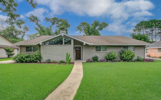 9818 Emnora Ln, Houston, TX 77080 - view of front of property with a front yard, a chimney, brick siding, and a shingled roof
