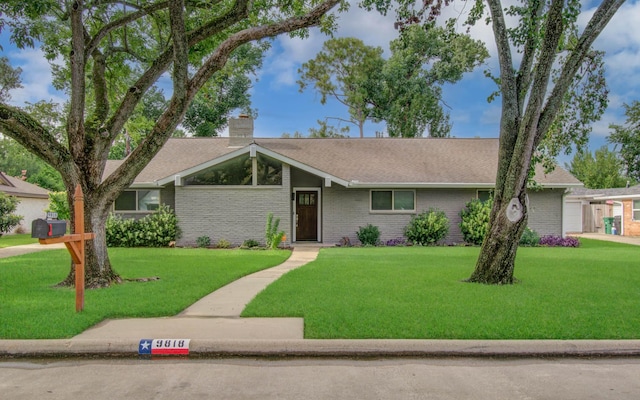 9818 Emnora Ln, Houston, TX 77080 - view of front of property with a chimney, a front lawn, and brick siding