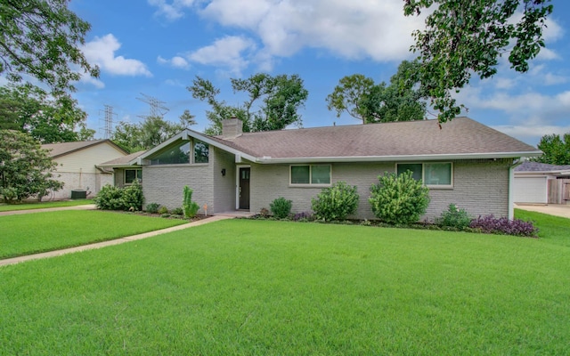 9818 Emnora Ln, Houston, TX 77080 - view of front facade with a chimney, a front lawn, brick siding, and roof with shingles