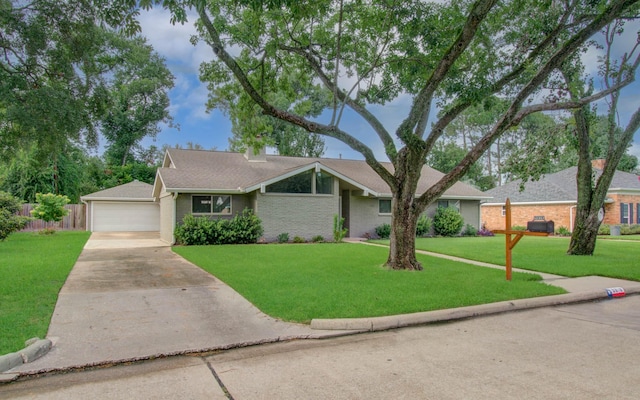 9818 Emnora Ln, Houston, TX 77080 - view of front of property with a garage, driveway, and brick siding