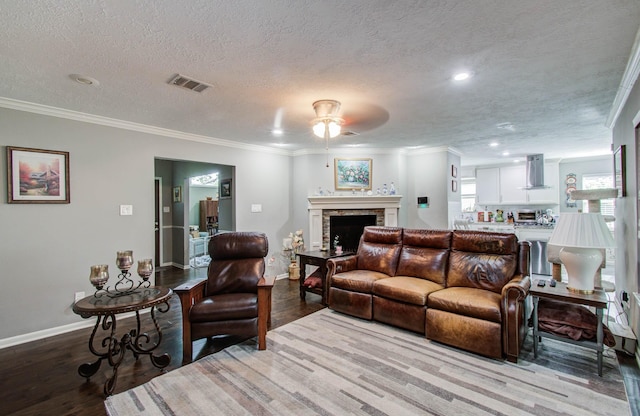 9818 Emnora Ln, Houston, TX 77080 - living area featuring ceiling fan, wood finished floors, crown molding, a textured ceiling, and a fireplace