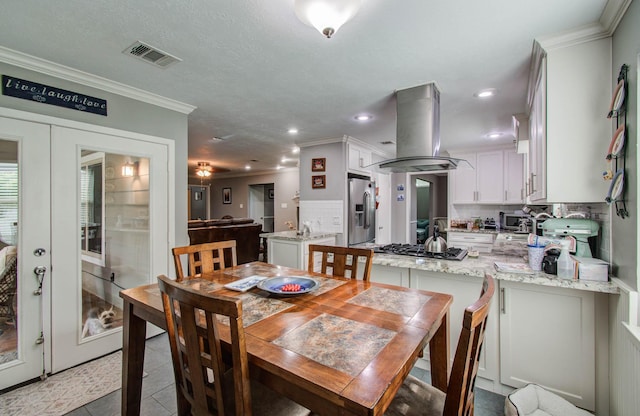 9818 Emnora Ln, Houston, TX 77080 - dining room featuring ornamental molding, light tile patterned floors, recessed lighting, and french doors
