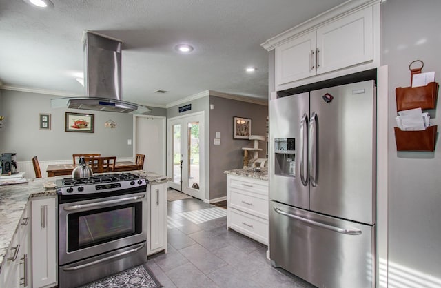 9818 Emnora Ln, Houston, TX 77080 - kitchen with stainless steel appliances, ventilation hood, ornamental molding, white cabinets, and recessed lighting