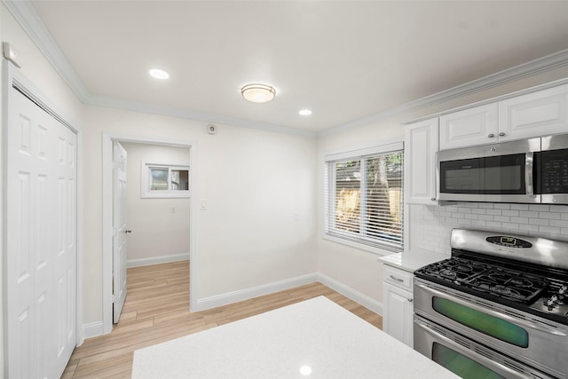 3815 Latma Dr, Houston, TX 77025 - kitchen with appliances with stainless steel finishes, backsplash, white cabinets, light countertops, and crown molding