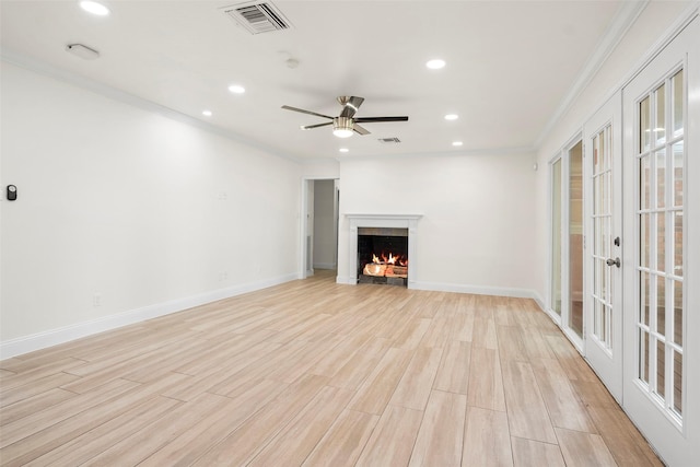 3815 Latma Dr, Houston, TX 77025 - unfurnished living room with crown molding, recessed lighting, a warm lit fireplace, ceiling fan, and french doors
