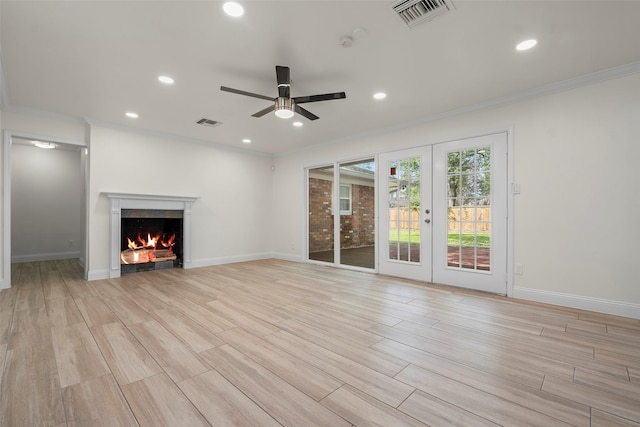 3815 Latma Dr, Houston, TX 77025 - unfurnished living room featuring ceiling fan, recessed lighting, french doors, light wood-style flooring, and a lit fireplace
