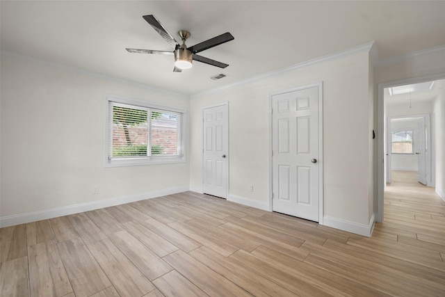 3815 Latma Dr, Houston, TX 77025 - unfurnished bedroom featuring attic access, crown molding, multiple windows, light wood finished floors, and a closet