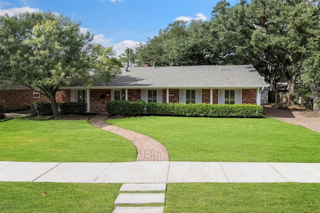 3815 Latma Dr, Houston, TX 77025 - ranch-style house featuring brick siding, a front yard, a shingled roof, and a chimney