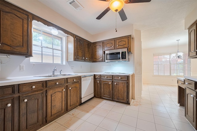2823 W Pebble Beach Dr, Missouri City, TX 77459 - kitchen featuring dishwasher, stainless steel microwave, ceiling fan, light countertops, and plenty of natural light