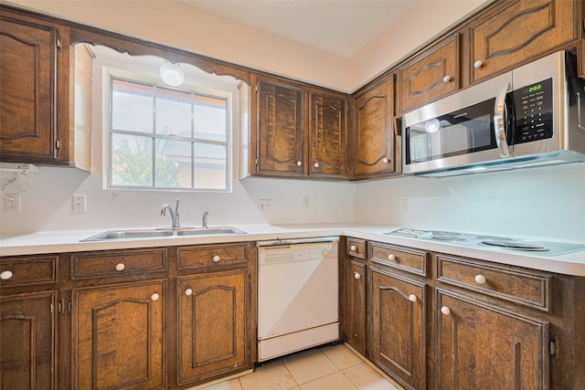 2823 W Pebble Beach Dr, Missouri City, TX 77459 - kitchen with white appliances, light countertops, and light tile patterned flooring