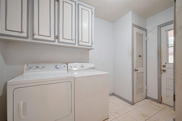 2823 W Pebble Beach Dr, Missouri City, TX 77459 - washroom with washer and clothes dryer, cabinet space, light tile patterned floors, and a textured ceiling