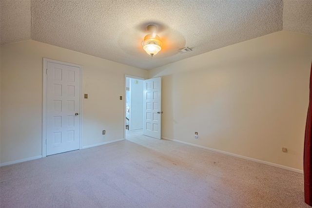 2823 W Pebble Beach Dr, Missouri City, TX 77459 - unfurnished room featuring lofted ceiling, light carpet, and a textured ceiling
