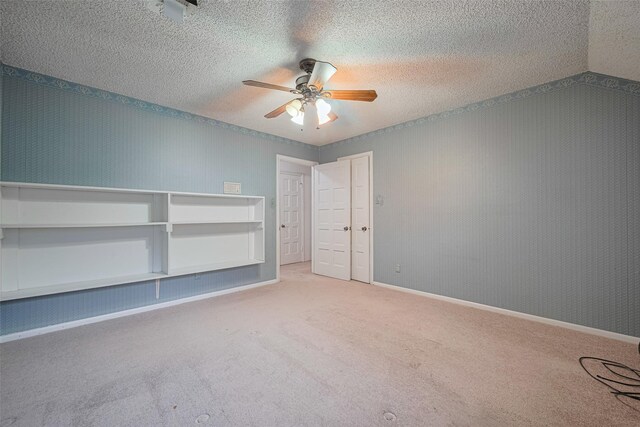 2823 W Pebble Beach Dr, Missouri City, TX 77459 - unfurnished bedroom featuring carpet floors, a ceiling fan, and a textured ceiling