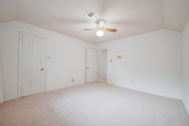 2823 W Pebble Beach Dr, Missouri City, TX 77459 - spare room featuring lofted ceiling, a ceiling fan, carpet flooring, and a textured ceiling