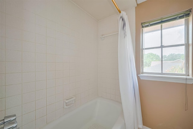 2823 W Pebble Beach Dr, Missouri City, TX 77459 - bathroom featuring shower / tub combo with curtain and baseboards