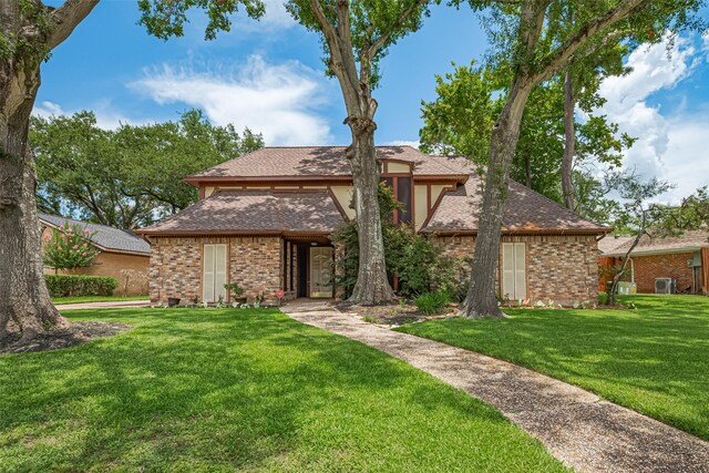 2823 W Pebble Beach Dr, Missouri City, TX 77459 - view of front facade featuring a front lawn, brick siding, and roof with shingles