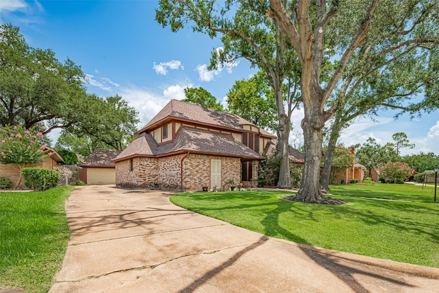 2823 W Pebble Beach Dr, Missouri City, TX 77459 - tudor home with a garage, a front yard, brick siding, and driveway