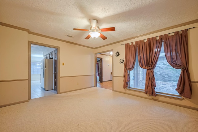 2823 W Pebble Beach Dr, Missouri City, TX 77459 - empty room with a ceiling fan, a textured ceiling, light carpet, and ornamental molding