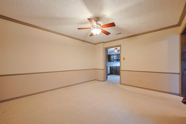 2823 W Pebble Beach Dr, Missouri City, TX 77459 - unfurnished room with ceiling fan, carpet, ornamental molding, and a textured ceiling
