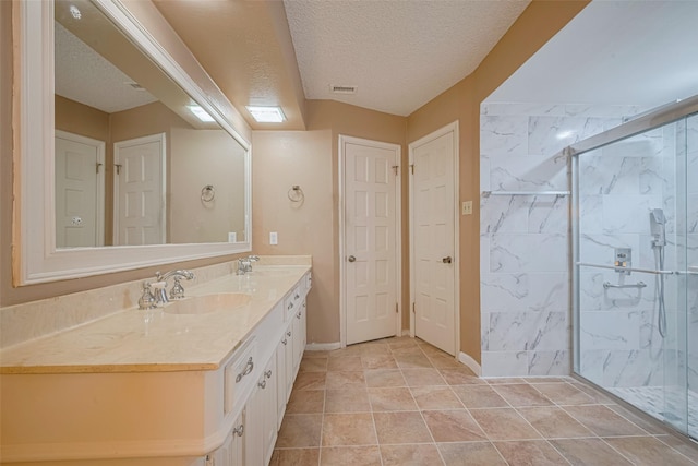 2823 W Pebble Beach Dr, Missouri City, TX 77459 - full bath with double vanity, a marble finish shower, and a textured ceiling
