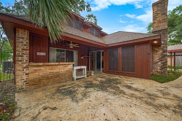 2823 W Pebble Beach Dr, Missouri City, TX 77459 - back of property featuring a ceiling fan, roof with shingles, a patio, a chimney, and board and batten siding