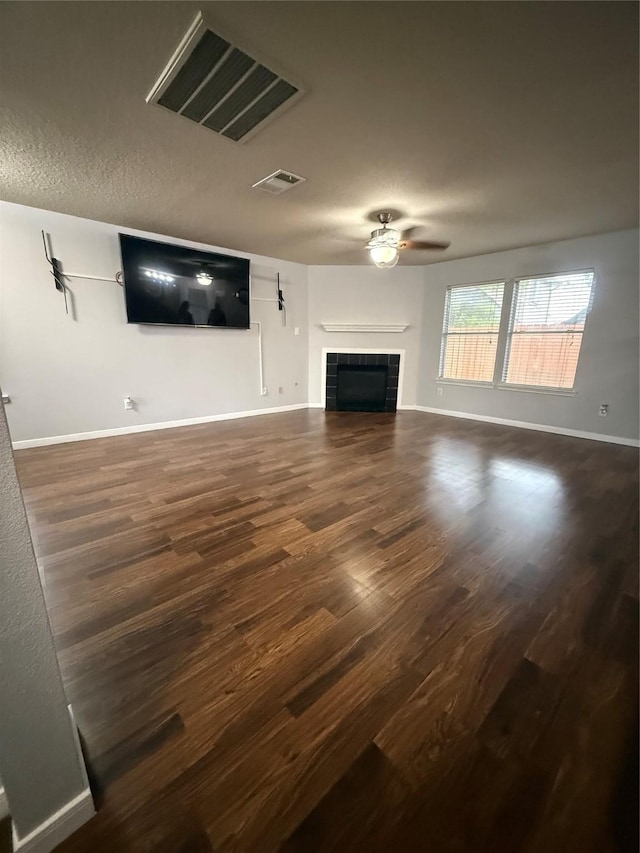 13202 Chasworth Dr, Houston, TX 77041 - unfurnished living room with dark wood-style flooring, a tile fireplace, and ceiling fan