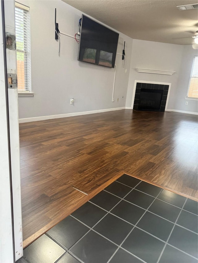 13202 Chasworth Dr, Houston, TX 77041 - unfurnished living room featuring wood finished floors, a tile fireplace, and ceiling fan