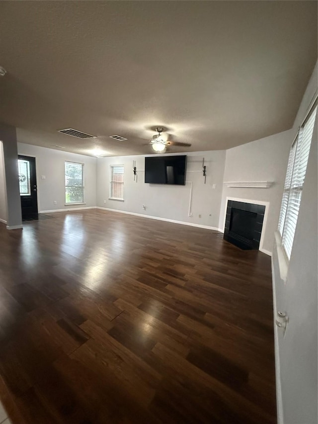 13202 Chasworth Dr, Houston, TX 77041 - unfurnished living room with dark wood finished floors, a tiled fireplace, and a ceiling fan