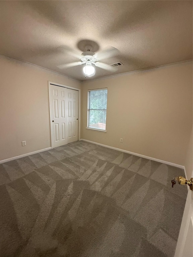 13202 Chasworth Dr, Houston, TX 77041 - unfurnished bedroom with carpet flooring, a textured ceiling, ceiling fan, crown molding, and a closet