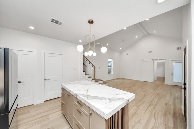 3907 Sumpter St, Houston, TX 77020 - kitchen featuring a center island, refrigerator, light wood finished floors, decorative light fixtures, and recessed lighting
