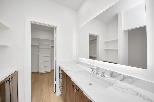 3907 Sumpter St, Houston, TX 77020 - bathroom featuring vanity, a walk in closet, and wood finished floors