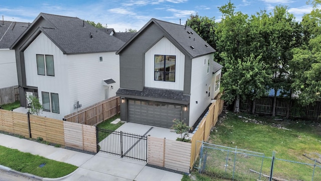 3907 Sumpter St, Houston, TX 77020 - view of front facade featuring a gate, concrete driveway, an attached garage, a fenced front yard, and a shingled roof