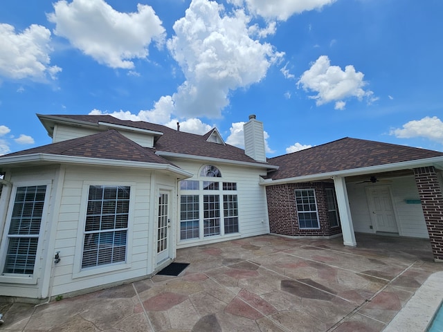 8123 Cove Timbers Ln, Tomball, TX 77375 - back of house featuring a patio, a chimney, a ceiling fan, and a shingled roof
