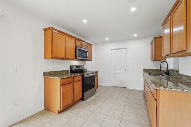 2607 Ensbrook Meadow Ln, Katy, TX 77449 - kitchen featuring stainless steel appliances, dark stone counters, recessed lighting, brown cabinetry, and light tile patterned floors