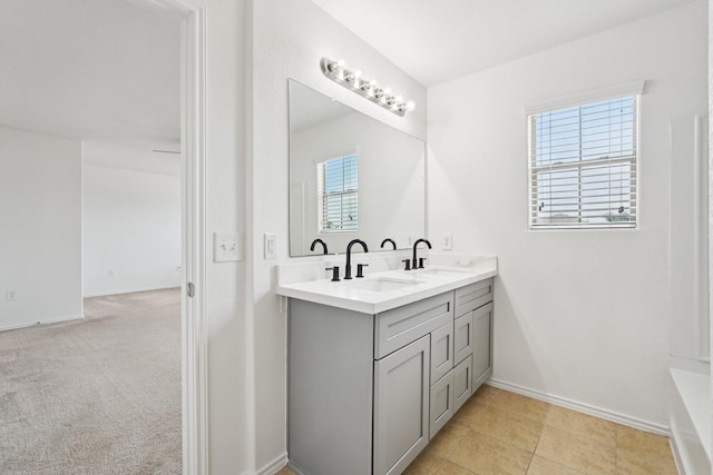 2607 Ensbrook Meadow Ln, Katy, TX 77449 - bathroom with double vanity, plenty of natural light, and a tub to relax in