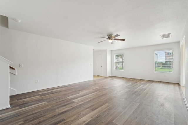 2607 Ensbrook Meadow Ln, Katy, TX 77449 - empty room featuring a ceiling fan, healthy amount of natural light, a smoke detector, and wood finished floors