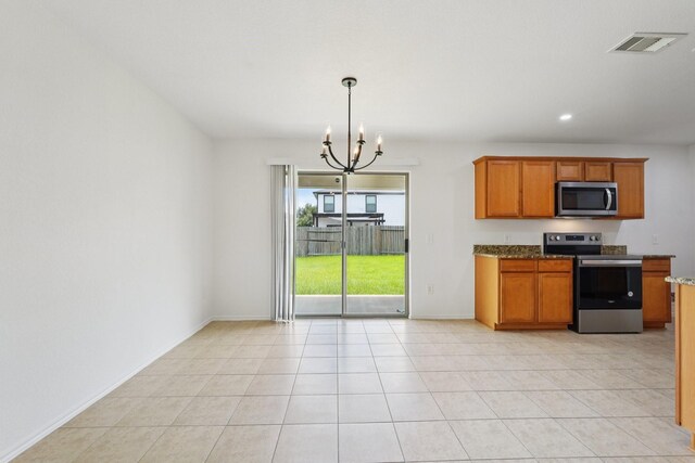 2607 Ensbrook Meadow Ln, Katy, TX 77449 - kitchen with appliances with stainless steel finishes, a chandelier, stone countertops, brown cabinets, and recessed lighting