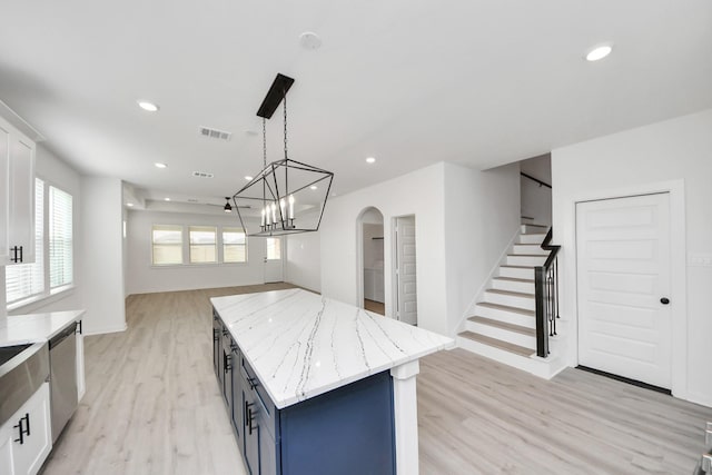 5318 Latigo Ct, Alvin, TX 77511 - kitchen with light wood-type flooring, dishwasher, white cabinets, blue cabinets, and recessed lighting