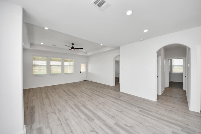 5318 Latigo Ct, Alvin, TX 77511 - empty room featuring arched walkways, ceiling fan, light wood finished floors, and recessed lighting