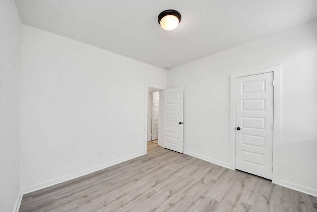 5318 Latigo Ct, Alvin, TX 77511 - unfurnished bedroom with wood finished floors and baseboards
