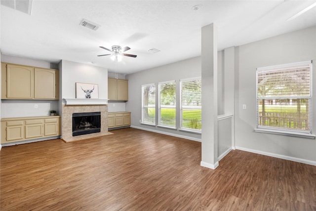 3327 Shady Glen Ln, Missouri City, TX 77459 - unfurnished living room with a ceiling fan, wood finished floors, and a tile fireplace